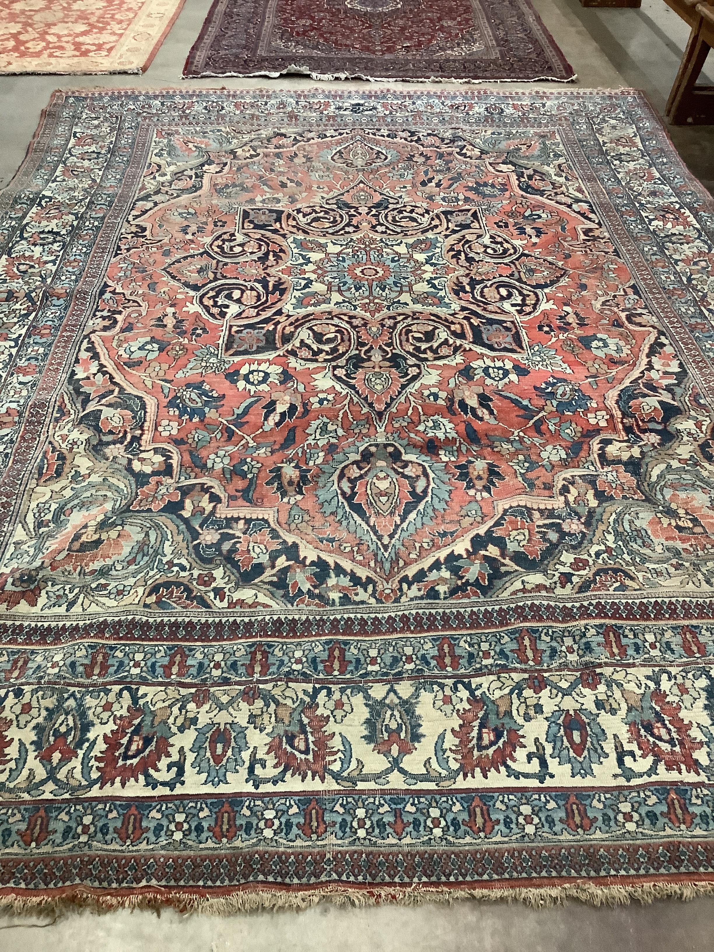 An early 20th century Heriz burgundy ground carpet, 380 x 276cm
